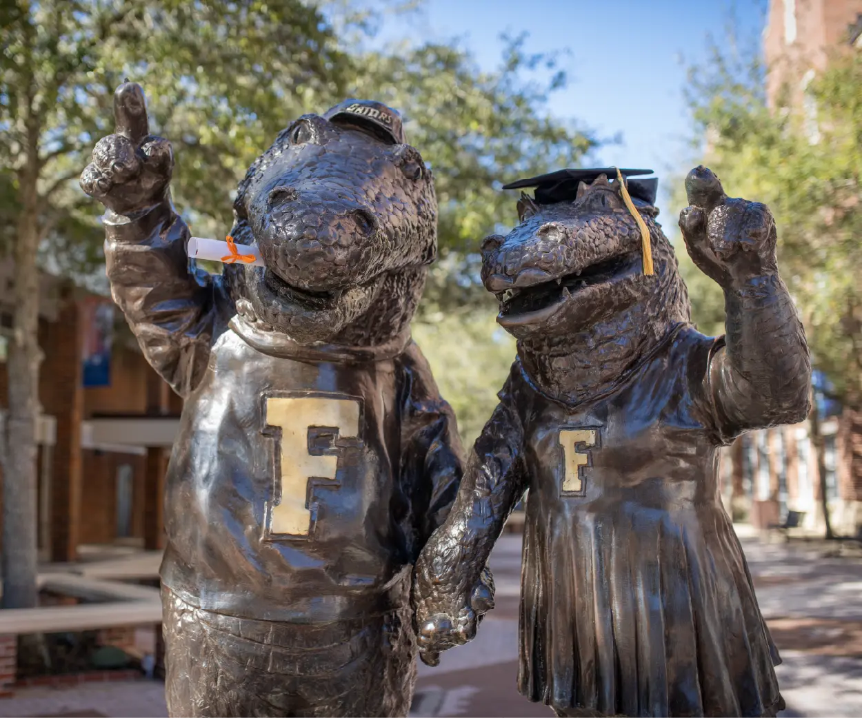 Statue of Albert and Alberta wearing graduation caps